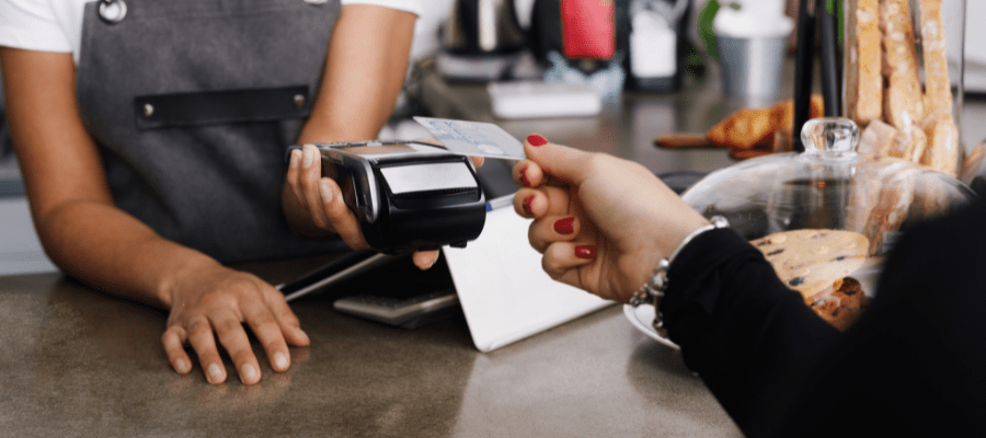 mit der Karte an einer Café-Theke bargeldlos bezahlen